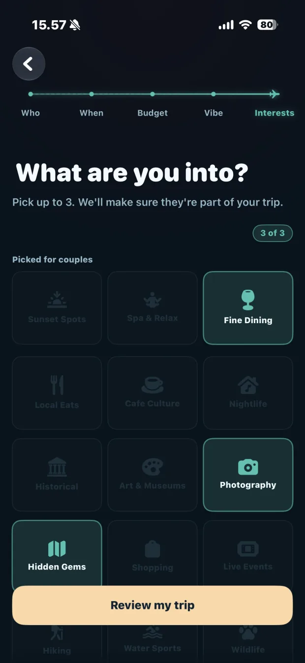 The interests screen: “What are you into? Pick up to 3. We’ll make sure they’re part of your trip.” Fine Dining, Photography and Hidden Gems are selected.